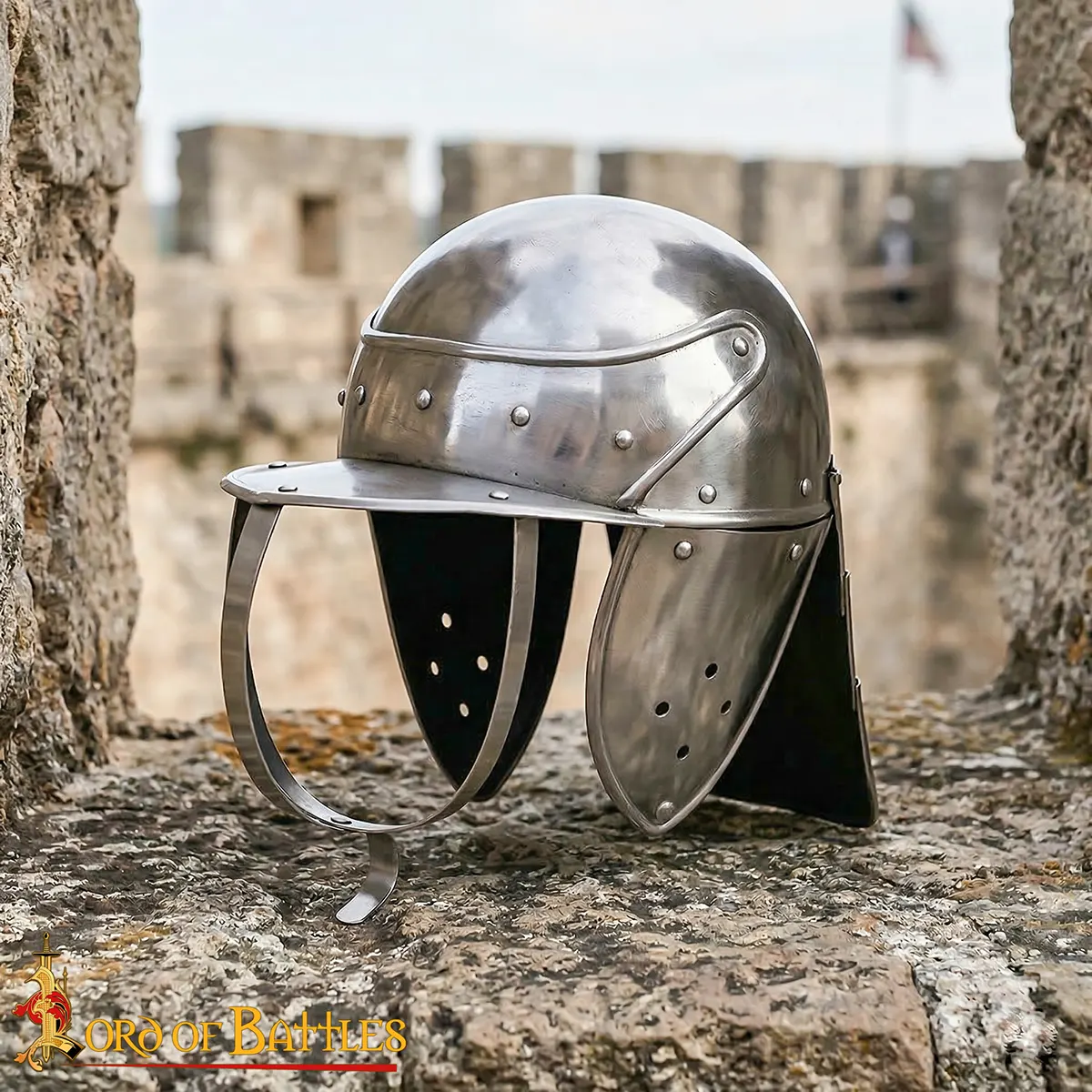 Shiny medieval knight's helmet resting on stone battlements with a blurred castle backdrop.